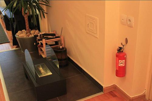 a room with a red fire extinguisher on the wall at Sunny Central Apartment in Sofia