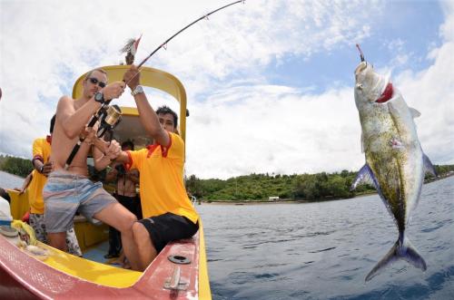 a group of people on a boat with a fish at Mayo Resort in Umeanyar
