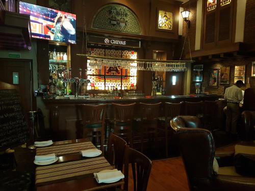 a bar with tables and chairs in a restaurant at The Palms Town & Country Club - Resort in Gurgaon
