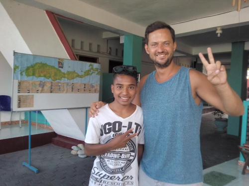 a man and a young boy giving the peace sign at Dasi Guesthouse in Ende