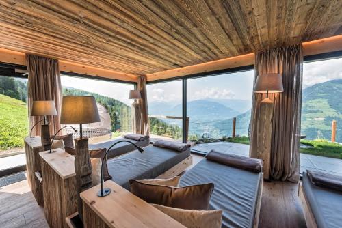 a bedroom with a view of a mountain at Mountain Lodge Prennanger in Schenna