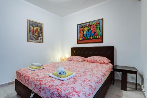a bedroom with a bed with a hat and towels on it at Sea Oasis Apartments - Milosevic in Kotor