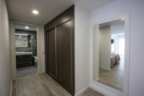 a hallway with sliding glass doors and a bathroom at Ona Don Juan in Lloret de Mar
