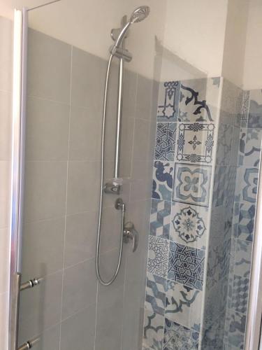 a shower with a glass door in a bathroom at Blue Sky Apartments in Capo dʼOrlando