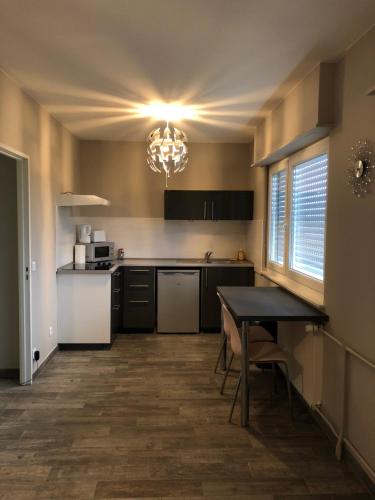 a kitchen with a table and a dining room at Executive Studios near Basel in Saint-Louis