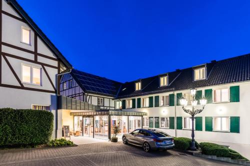 a car parked in front of a building at Waldhotel Eskeshof in Wuppertal