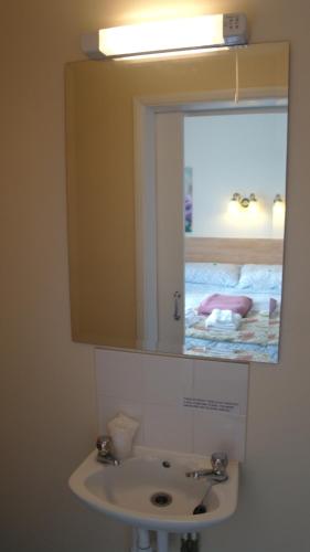 a bathroom with a sink and a mirror at The Monsell Hotel in Skegness