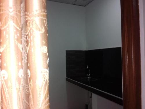 a shower curtain in a room with a sink at Mirissa Green Villa in Mirissa