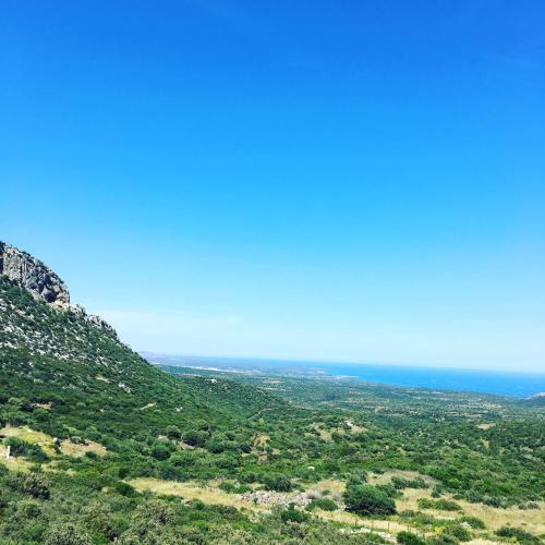 a view of the ocean from the top of a hill at Casa M&M in Cala Gonone