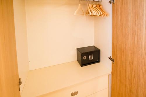 a bathroom with a small black box on the wall at Confort Escaldes HUT 5003 - HUT 7755 in Andorra la Vella