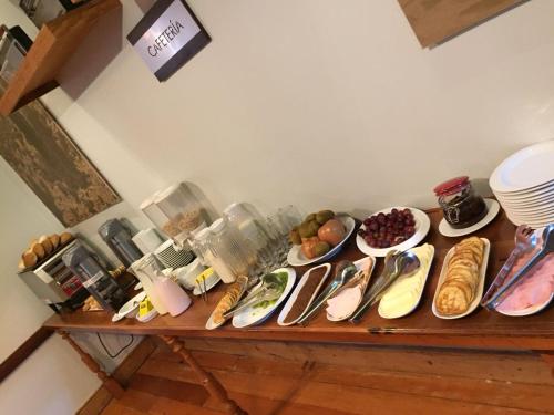 a table with many plates of food on it at Hotel Baquedano Boulevard in Iquique