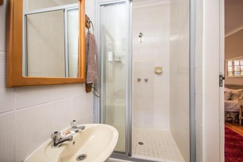 a bathroom with a sink and a shower at Warrens Guest House in Hillcrest