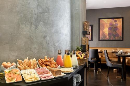 a buffet of food on a table in a restaurant at Régence Etoile in Paris