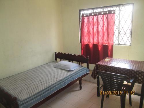 a room with two beds and a window at St. Antonys Lodge in Cochin