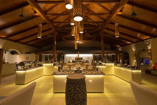 a large room with tables and chairs in it at Coco de Mer Hotel and Black Parrot Suites in Grand'Anse Praslin