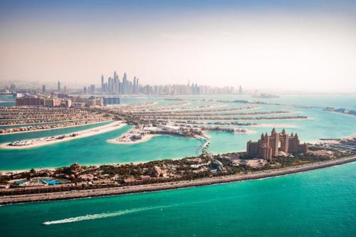 an aerial view of a city and the ocean at Royal Central Hotel and Resort The Palm in Dubai