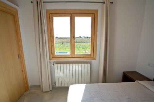 a bedroom with a bed and a window at Finca Sa Carrotja in Porto Cristo
