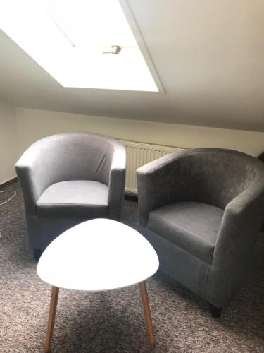 two chairs and a table in a room at Penzion Ema B&B in Prostějov