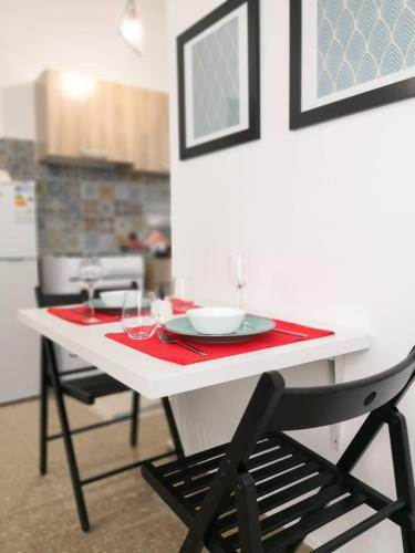 a white table with a plate on it in a kitchen at Cheerful Apartment in Nicosia in Yukarı Lakatamya