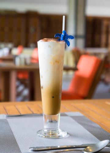 a drink in a glass sitting on a table at Rajapruek Samui Resort - SHA Plus in Lipa Noi