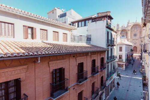 a view of a city street with buildings at Pension Mesones in Granada
