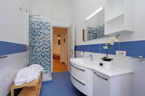 a bathroom with a white sink and a shower at Traiano Charme - My Extra Home in Rome