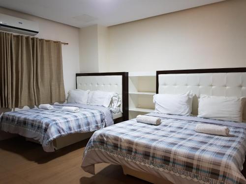 two beds sitting next to each other in a room at Hotel Giorgio in General Santos