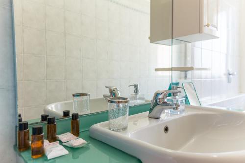 a bathroom with a sink and a mirror at Linate Airport Apartment in Milan