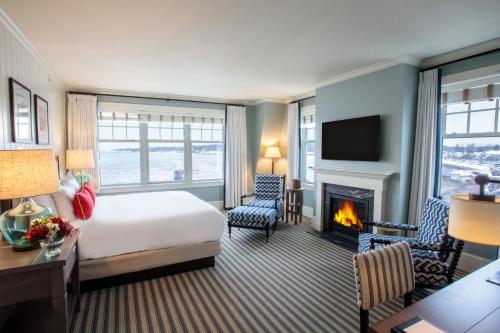 a hotel room with a bed and a fireplace at Beauport Hotel Gloucester in Gloucester