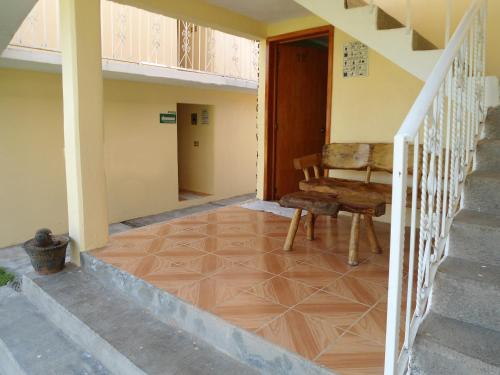 a stairway with a bench sitting on a tiled floor at Posada Dos Hermanos in Huasca de Ocampo