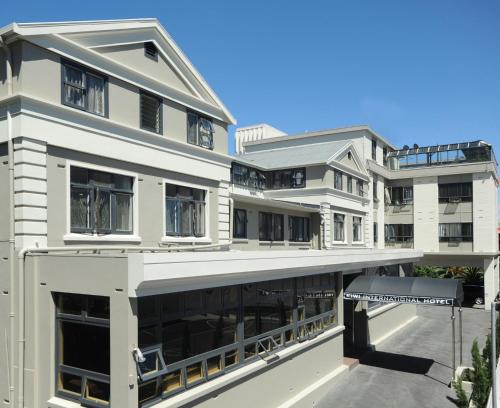 an external view of a white building at Kiwi International Hotel in Auckland