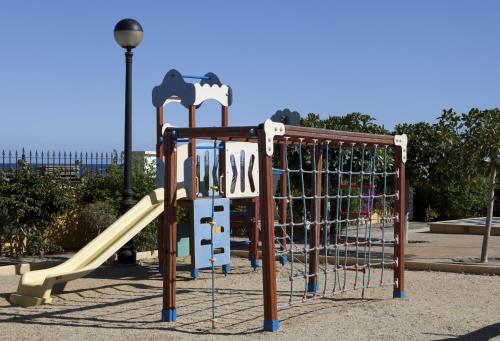 a playground with a slide in a park at Playazimbali in Vera