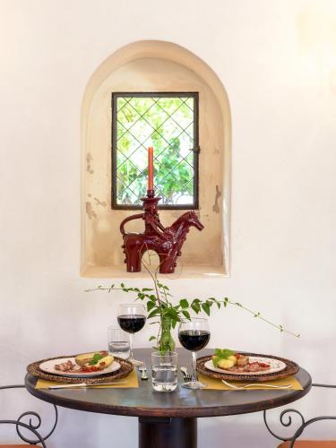a table with two plates of food and a window at Masseria Marzalossa in Fasano