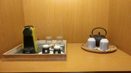 a tray with a tea kettle and glasses on a table at Domus 26 Guesthouse - B&B in Braga