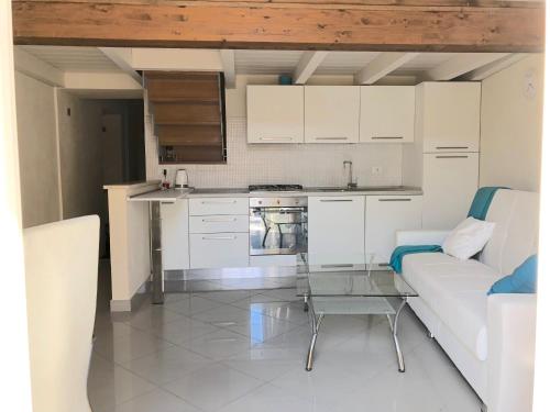 a kitchen with a couch and a table in a room at ABCdecor Italia in Imperia
