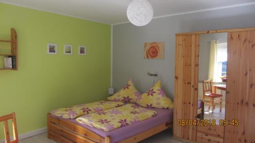 a bedroom with a bed and a wooden cabinet at Fewo Jahn in Bad Schandau