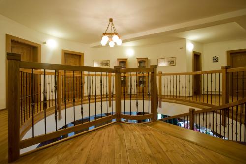 a room with a wooden staircase with a chandelier at Penzión Paula in Tatranská Lomnica