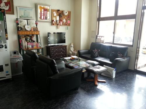 a living room with two couches and a coffee table at Hotel Wakasato in Nagano