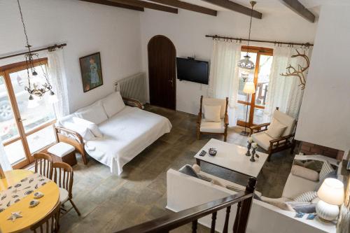 a living room with a white couch and a table at Villa Umami in Makri