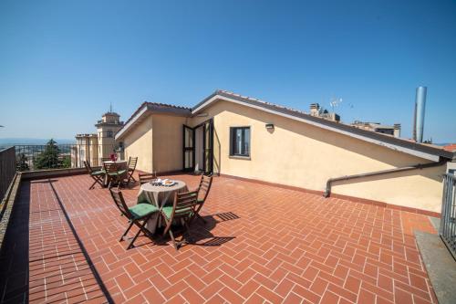 a patio with a table and chairs on a roof at Hotel Italia & Lombardi in Montefiascone