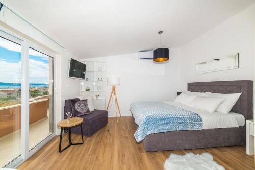 Postel nebo postele na pokoji v ubytování Apartmani Ana