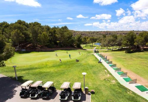 a row of cars parked on a golf course at El Mirador De Villamartin - La Zenia & Golf in Playas de Orihuela