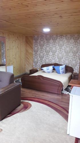 a bedroom with a large bed in a room at U Romana in Yaremche