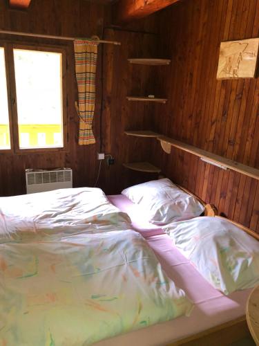 a bedroom with a bed in a wooden room at Chata Pribisko 651 in Zuberec