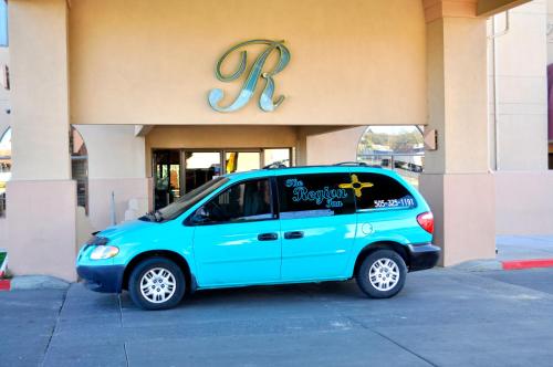 a small blue car parked in front of a store at Wingate by Wyndham Farmington NM in Farmington