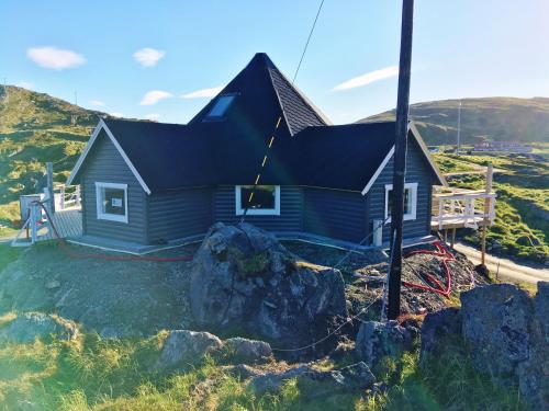 a house on the side of a hill at Cape Marina Lodge in Skarsvåg