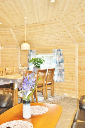a living room with a dining room table and chairs at Cape Marina Lodge in Skarsvåg