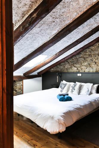 a bed with white sheets and pillows on it at Hostal Cisco de Sans in Andorra la Vella