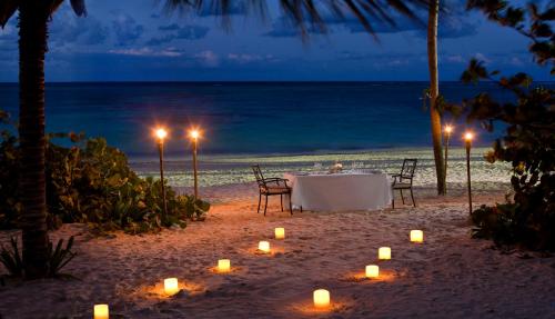 a table with candles on the beach at night at Meliá Punta Cana Beach Wellness Inclusive - Adults only in Punta Cana