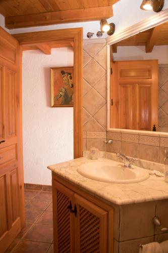 a bathroom with a sink and a mirror at AT Restaurante El Palacil in Vélez Blanco